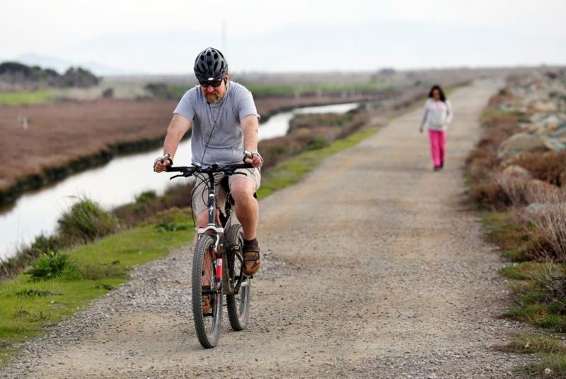 Cyclist and Pedestrian on Bay Trail at Hayward Regional Shoreline by Michael Short