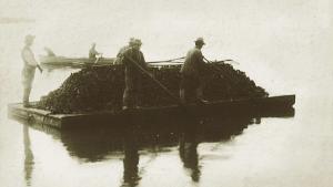 Sepia photo of oyster fishers in the bay