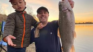 fisherman and son with rainbow trout