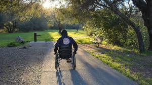 Trail user with wheelchair on wheelchair-friendly trail