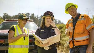 Fire Chief Aileen Theile (middle) planning flammable vegetation removal.