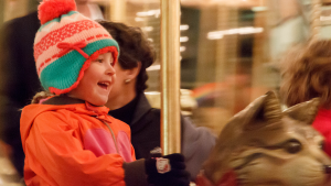 Child smiling on Merry-Go-Round