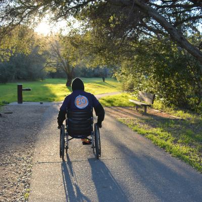 Trail user with wheelchair on wheelchair-friendly trail
