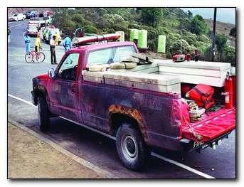 Red pickup truck with burns on it