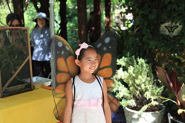 Child wearing butterfly wings