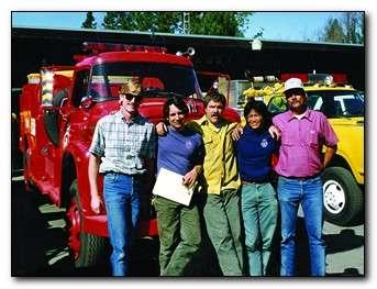 Group of people standing in front of a fire engine