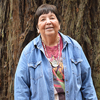 Ruth Orta standing in front of a tree