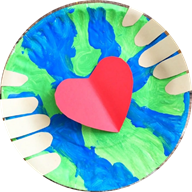 Circular image of paper plate painted to look like planet earth with a red heart at the center and fingers holding it up